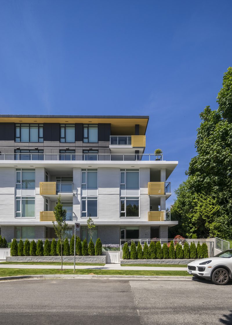 A car driving by the Belpark condominium in Vancouver BC